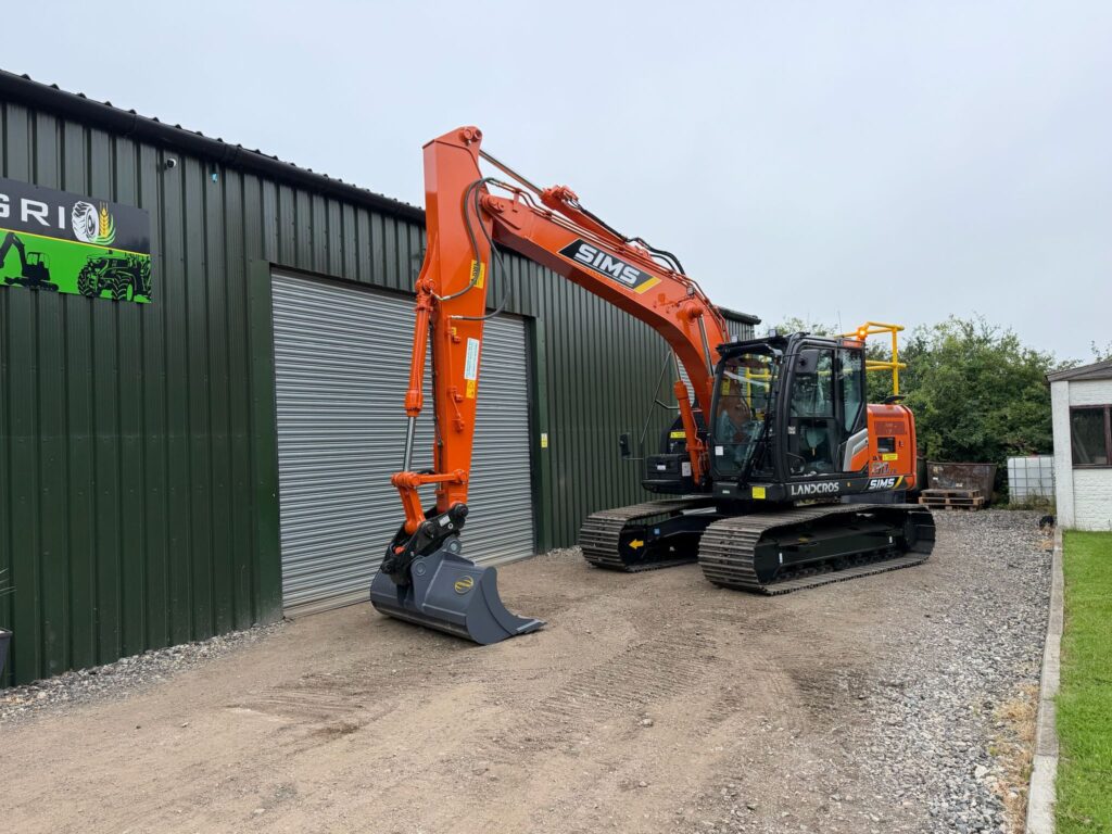 Orange Hitachi excavator parked outside the Sims Plant Hire depot