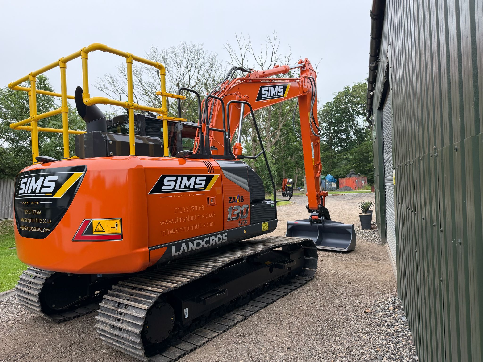 Rear view of an orange Sims excavator transported for plant hire in Southampton