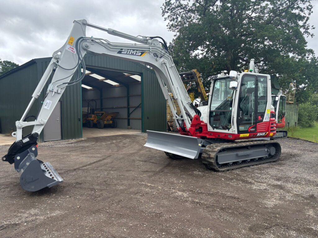 Two Takeuchi excavators parked side by side at the Sims Plant Hire yard for the UK construction plant hire equipment fleet