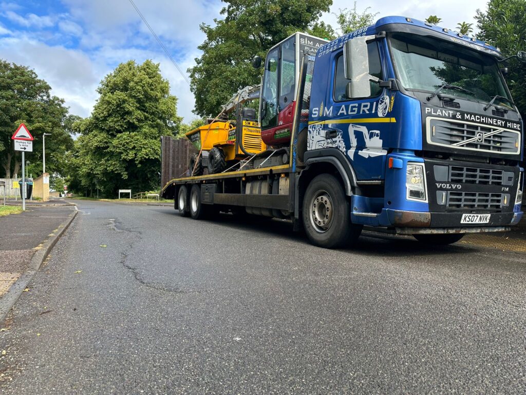 Sims lorry transporting backhoe loaders for plant hire projects in the UK