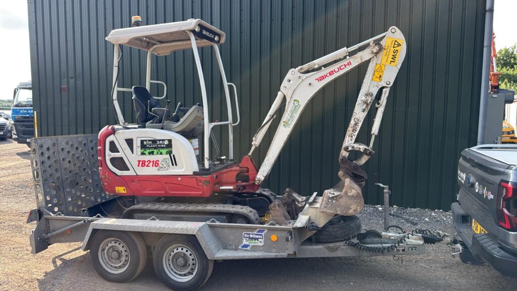 Takeuchi mini excavator secured on a plant transport trailer for the UK construction plant hire equipment fleet