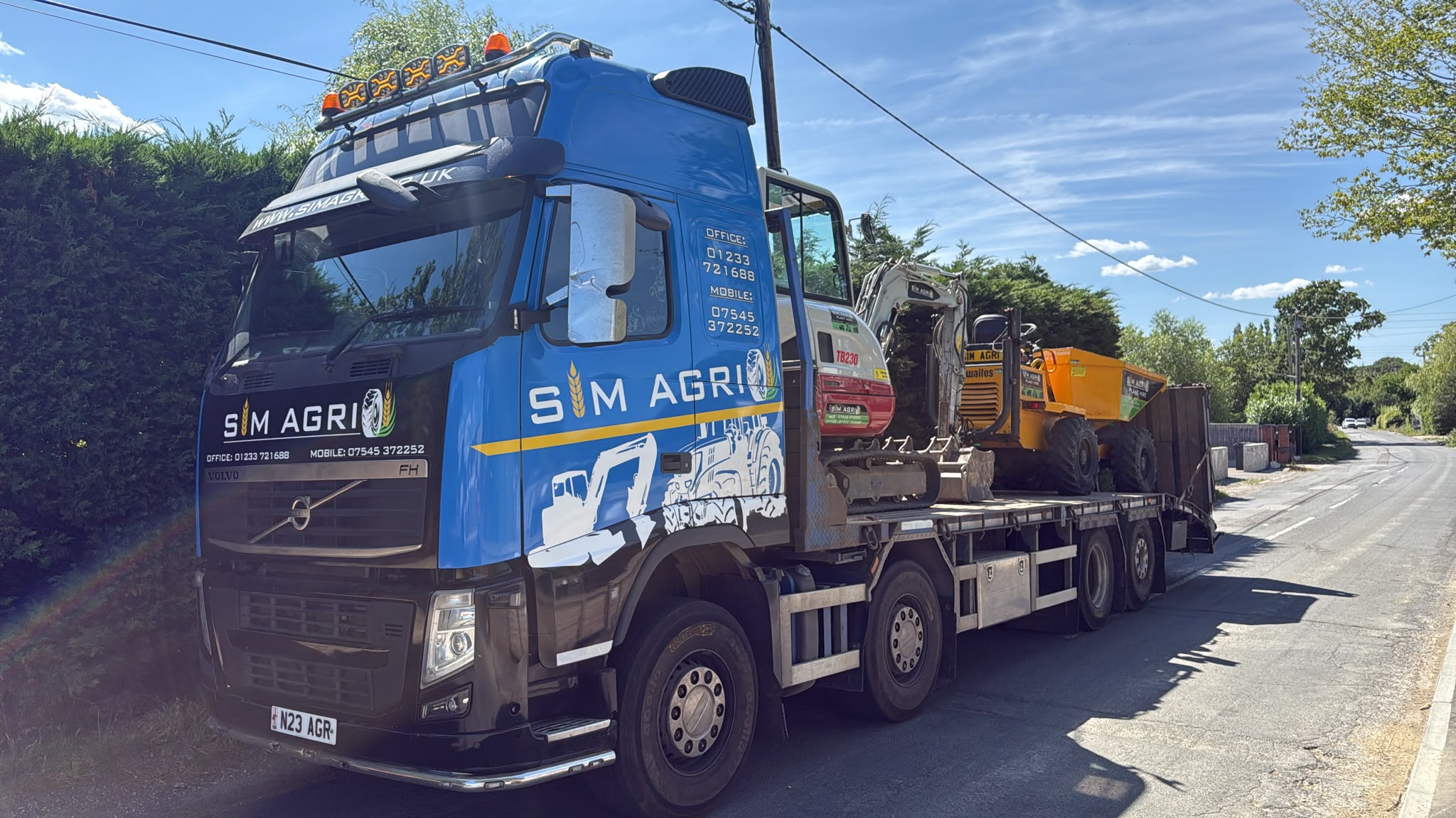 Sims low-loader transporting equipment for domestic plant hire