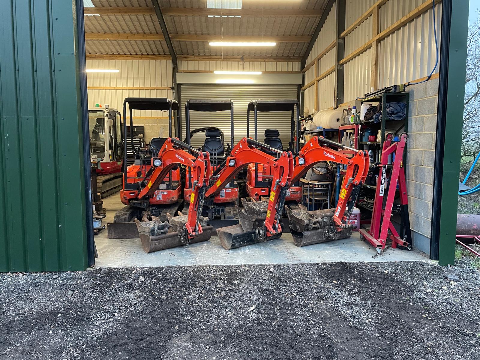 Red mini excavators lined up for plant hire in Nottingham