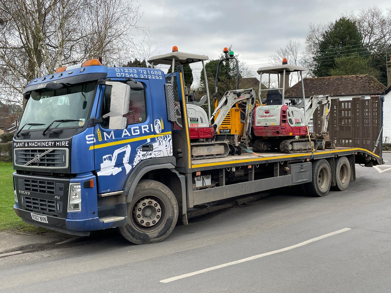 Sims low-loader transporting machinery for plant hire in Swindon