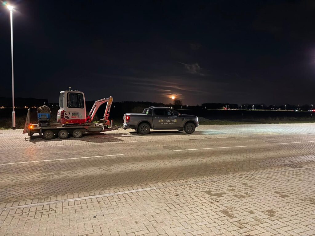 Plant equipment being transported at night for the excavator hire across the UK