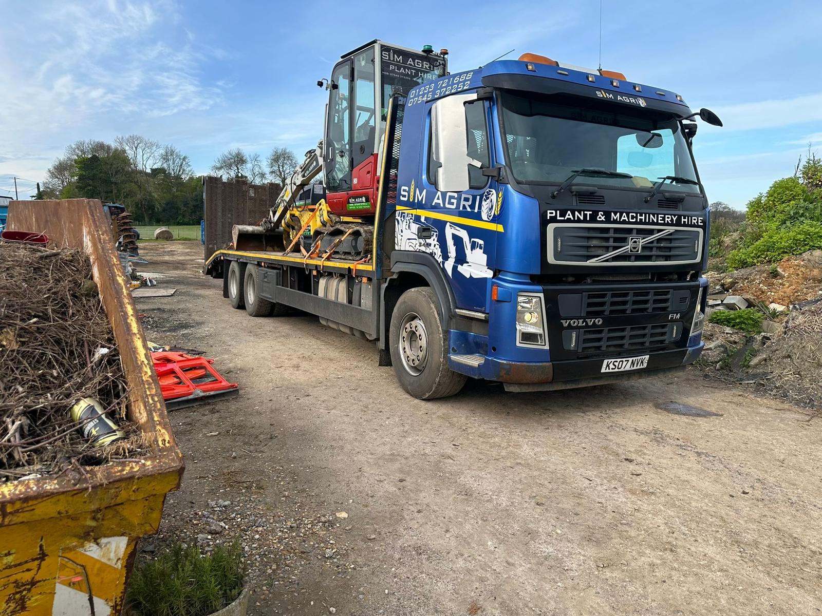 Sims low-loader carrying construction equipment for plant hire in Cambridgeshire