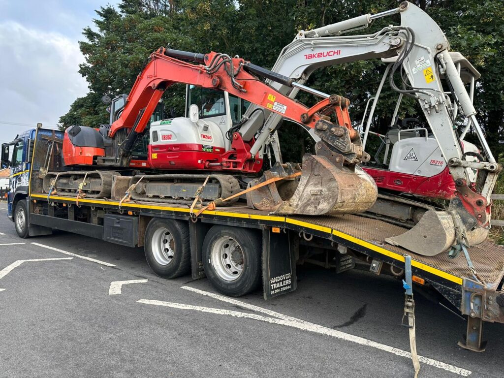 Sims low-loader carrying three mini excavators for commercial plant hire
