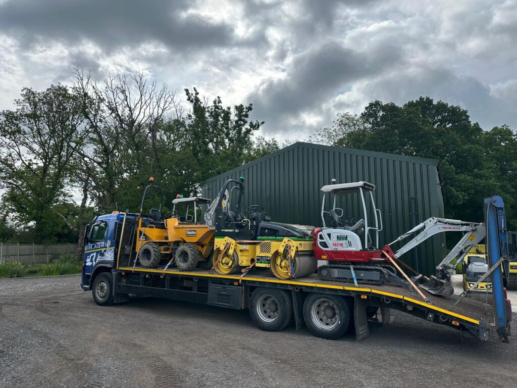 Sims low-loader carrying site dumpers and a compact excavator for the plant hire projects across the UK