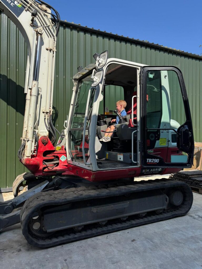 Operator seated in a Takeuchi compact excavator for the groundworks machinery available in the UK