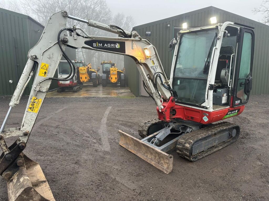 Mini excavator secured to a trailer for plant hire in Ashford