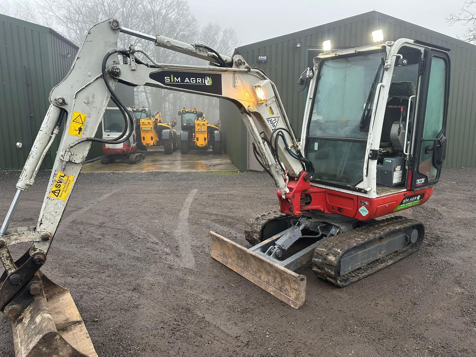 Mini excavator secured to a trailer for plant hire in Ashford
