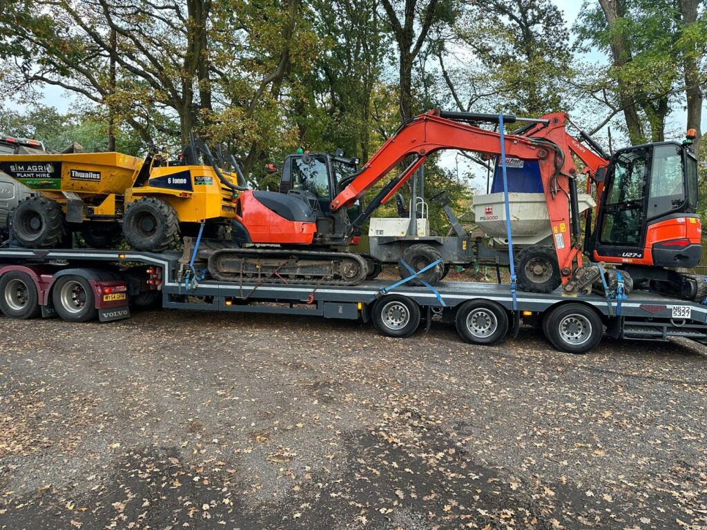 Low-loader carrying excavators and dumpers for construction plant hire contact