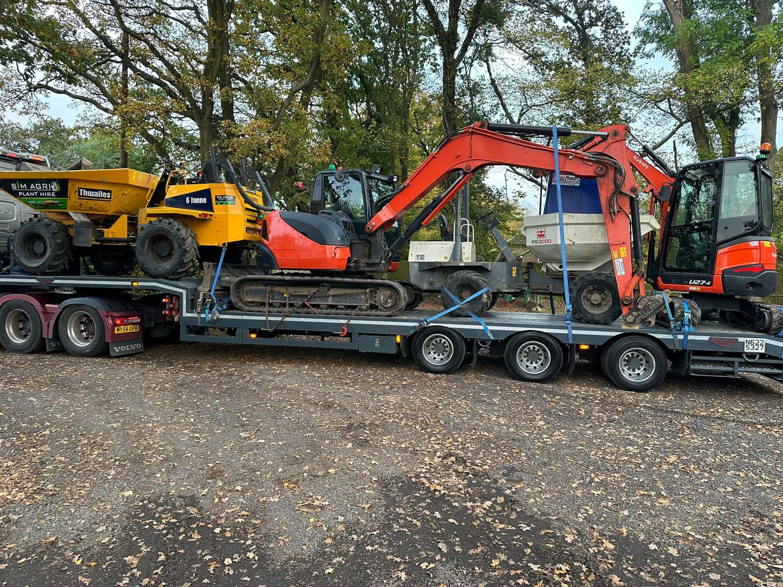 Low-loader carrying excavators and dumpers for construction plant hire contact