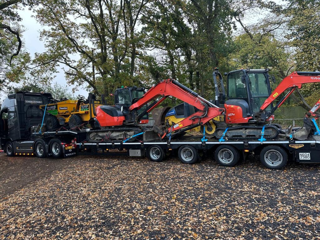Sims low-loader carrying dumpers and excavators for plant hire in Ashford