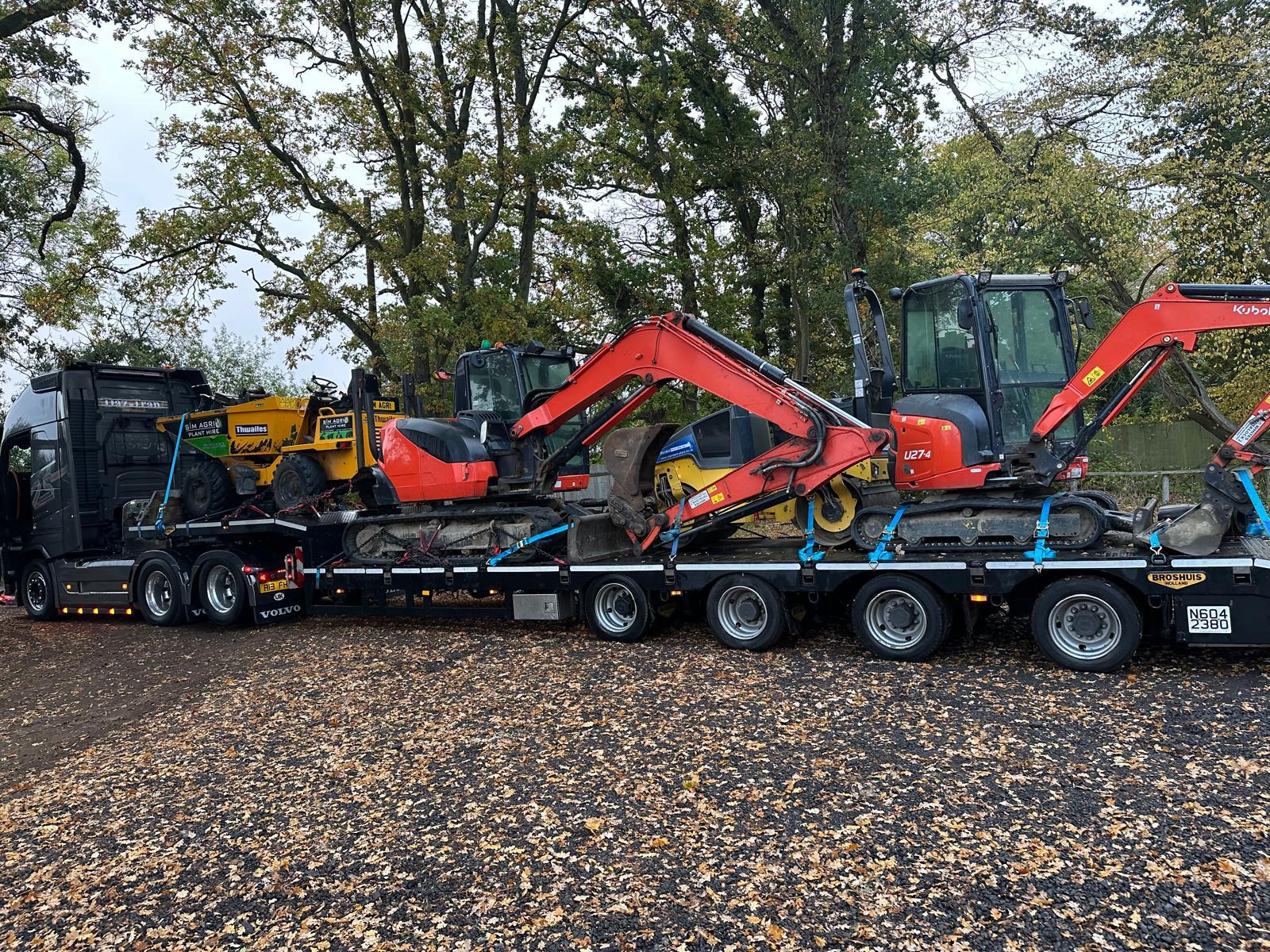 Sims low-loader carrying dumpers and excavators for plant hire in Ashford