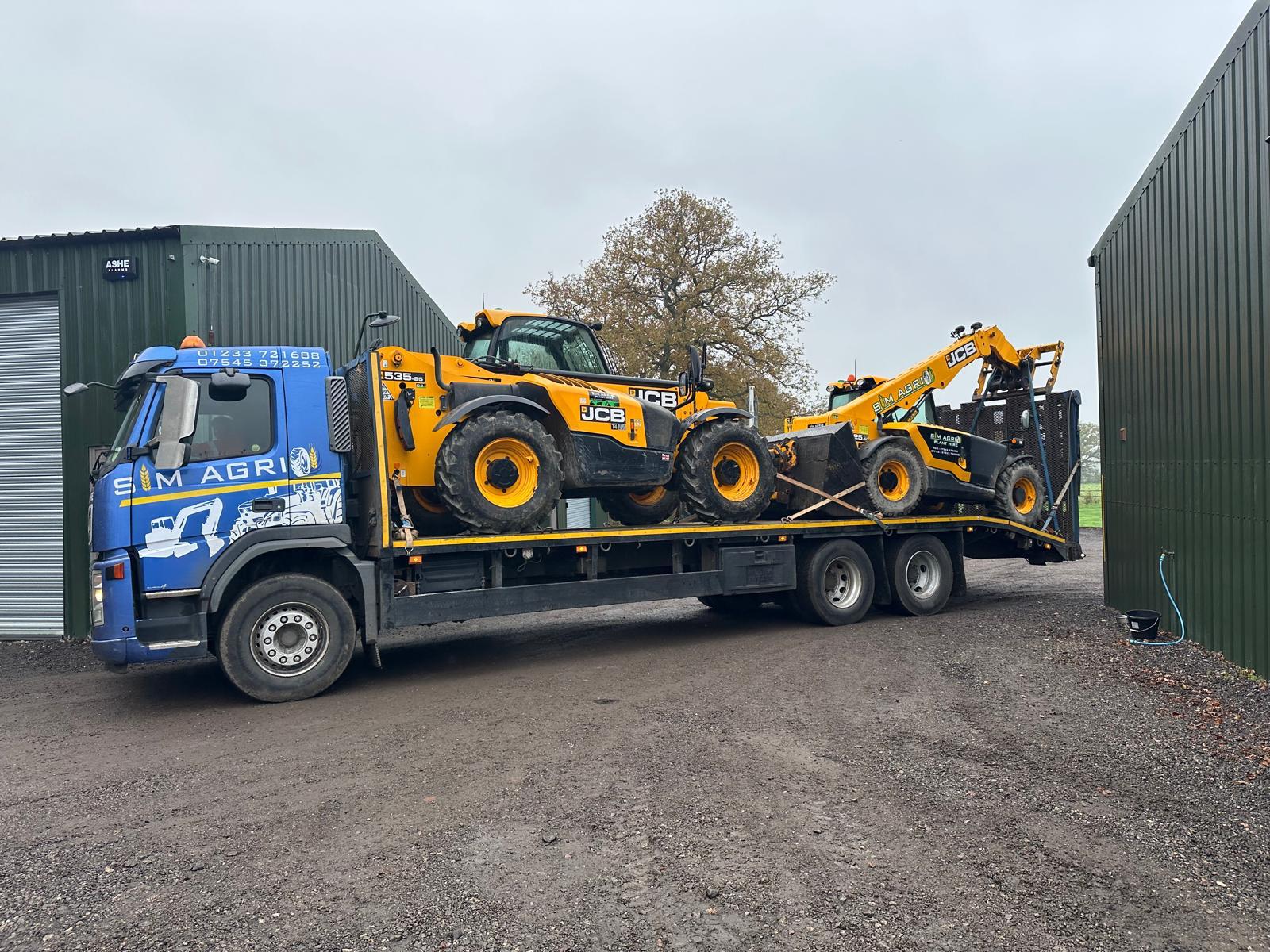 Sims low-loader transporting plant for hire in Oxfordshire