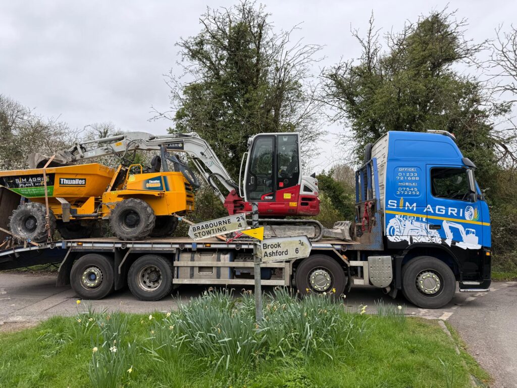 Sims low-loader carrying dumpers and a compact excavator for the UK construction plant hire equipment fleet