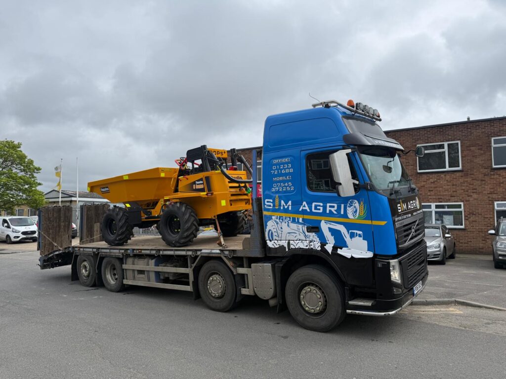 Sims low-loader transporting a yellow site dumper for the groundworks machinery available in the UK